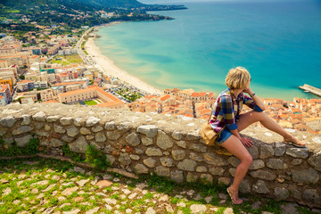 young woman looking to the Cefalu, Sicily
