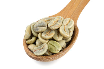 green coffee beans in a wooden spoon