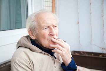 old man smoking a cigarette