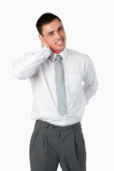 Portrait of a young businessman having a back pain