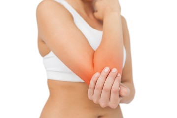 Young sporty woman touching her sore elbow