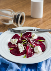 beet salad with goat cheese, garlic and sesame seeds