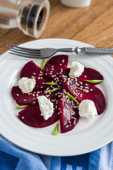 beet salad with goat cheese, garlic and sesame seeds