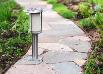 Solar-powered lamp on garden path.