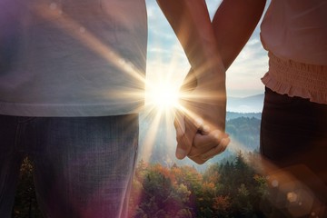 Composite image of young couple holding hands in the park - Powered by Adobe