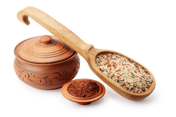 clay pot, wooden spoon and saucer with rice