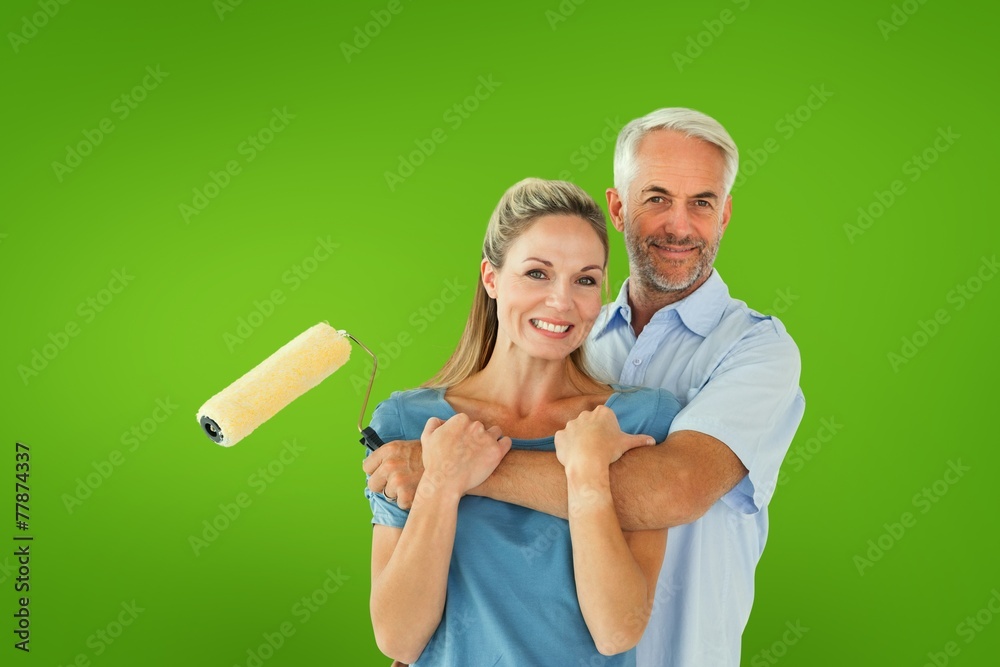 Poster composite image of happy couple hugging and holding paint roller
