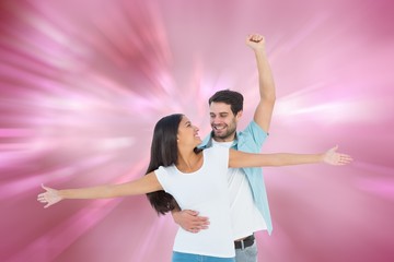 Composite image of happy casual couple cheering together