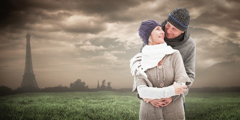 Happy mature couple in winter clothes embracing