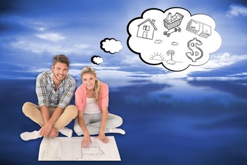 Obraz premium Attractive young couple sitting looking at blueprint