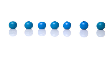 Blue round wooden beads over white background