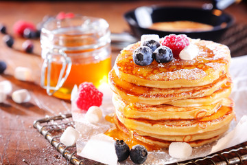 Stack of fresh golden pancakes or flapjacks