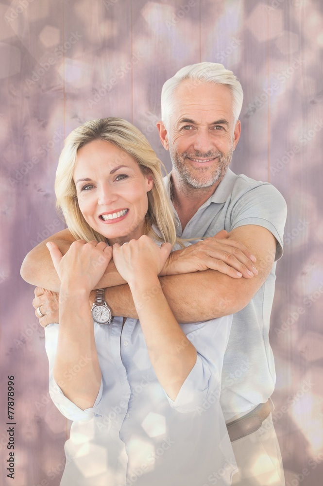 Poster Composite image of happy couple standing and hugging
