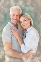 Composite image of happy couple standing and smiling at camera