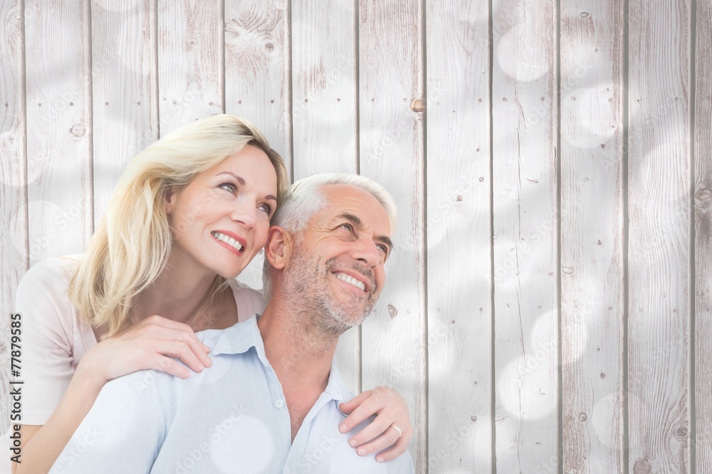 Poster composite image of smiling couple embracing and looking