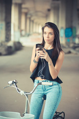 young beautiful brunette straight hair woman using bike and smar