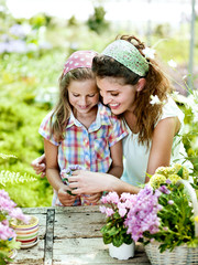 Mom and daughter have fun in the work of gardening