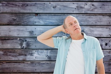 Composite image of thoughtful older man looking up