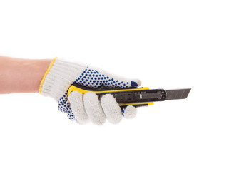 Hand in gloves holding knife.