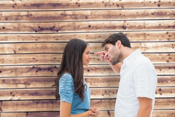 Composite image of angry man shouting at upset girlfriend