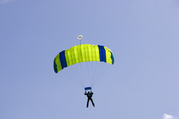 Parachutist jumping on a background of blue sky