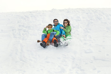 Fototapeta na wymiar Family having fun in the snow
