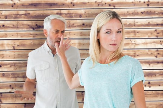 Composite image of woman not listening to her angry partner