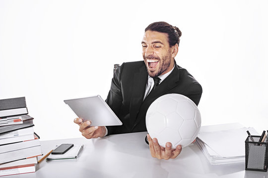Business Man Bet on football match while working