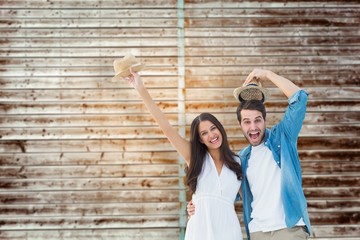 Happy hipster couple smiling at camera and cheering