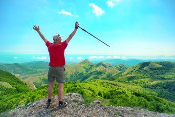 Young happy man with hiking stick