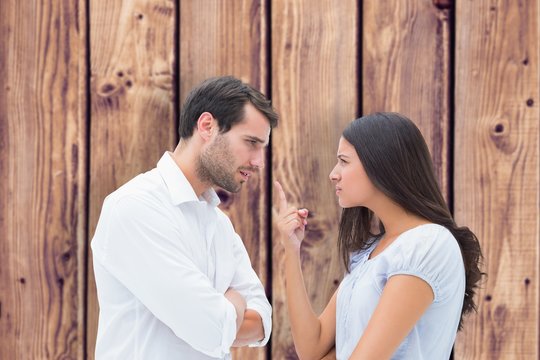 Composite image of angry couple facing off during argument