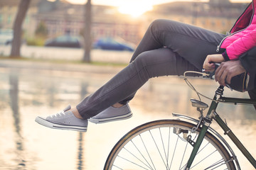 woman carried by his boyf on a bike crossing legs