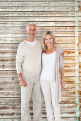 Composite image of happy couple smiling at camera together