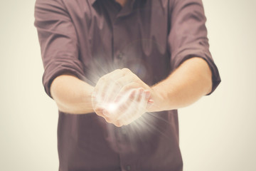 Man trying to hold the light between hands