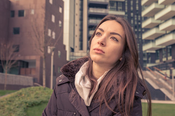 Fototapeta premium Young beautiful girl posing in the city streets