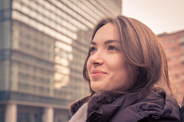 Young beautiful girl posing in the city streets