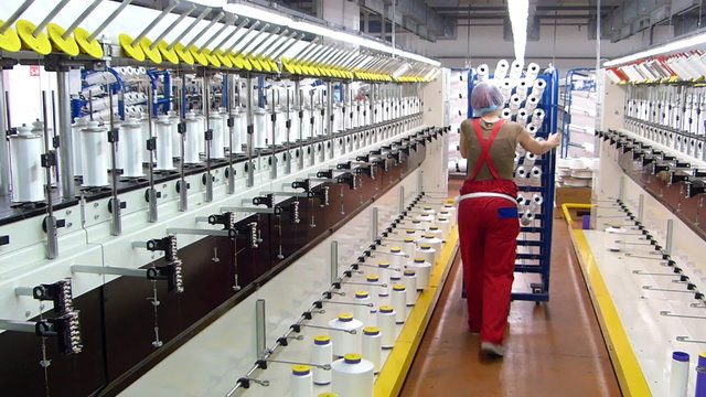 Textile manufacturing of synthetic fibers, woman working