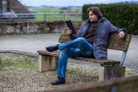 Man with tablet outdoor