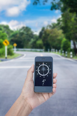 hand hold compass on smart phone on road