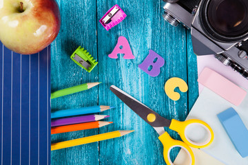 Office and school supplies on wooden surface