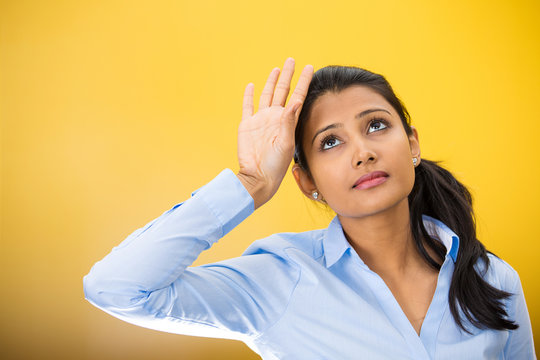 Headshot annoyed young woman isolated on yellow background 