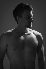 Fototapeta premium Strong athletic man on dark background