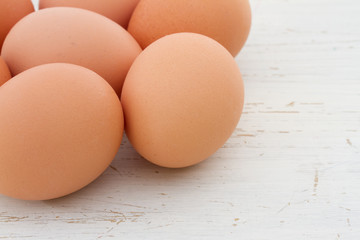 Brown eggs on a white shabby table
