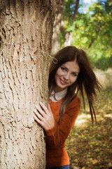 Beautiful girl walking in the autumn forest 