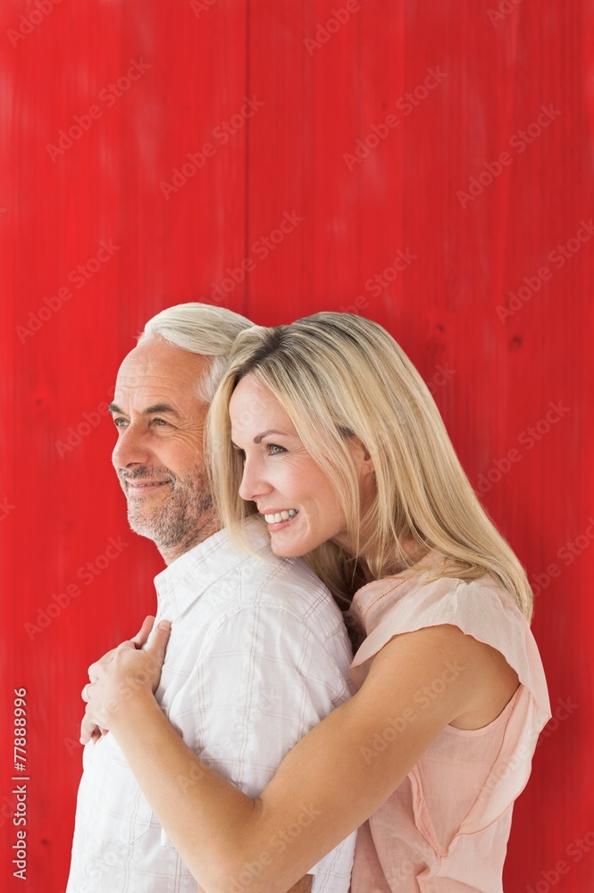 Aufkleber Composite image of affectionate couple standing and hugging
