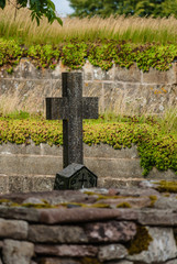 Graveyard with stone cross at an old monastery ruin.