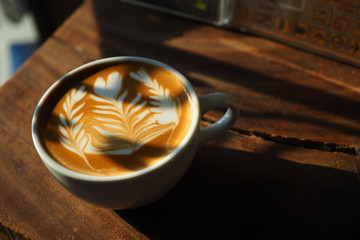 cup of coffee latte art on the wood background in vintage color