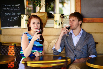 Couple enjoying their red wine in a cafe