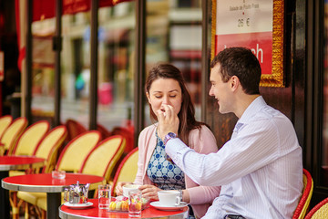 Couple drinking coffee or tea in a Parisian cafe