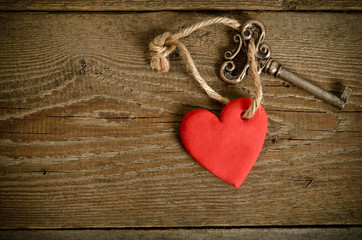 Handmade Heart with key together lying on a wooden  board
